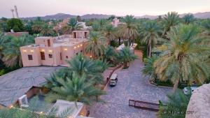 an aerial view of a house with palm trees at نزل البستان Bustan lnn in Nizwa