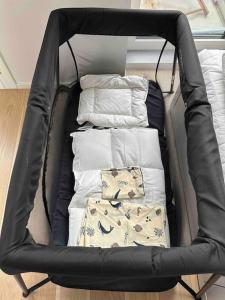 a black chair with some pillows in it at AArhus 115 in Aarhus
