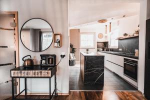 a kitchen with a sink and a mirror at Feels like home in Ralingen