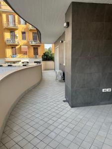 an empty courtyard with a building in the background at NLM Boutique Suites in Rome