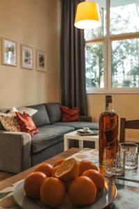 a living room with a table with a bottle of whiskey at Apartament 3 in Polanica-Zdrój