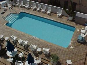 a large swimming pool with chairs and tables at Wesley Paradise Chic1BD Private Balcony and Pool in Ocean City