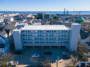 a large building with cars parked in a parking lot at Wesley Paradise Chic1BD Private Balcony and Pool in Ocean City