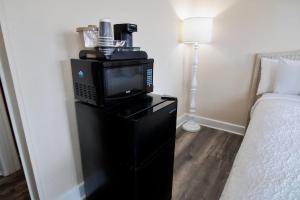 a room with a bed and a television on a black cabinet at 3rd Floor Close to Beach Sleeps 4 in Pawleys Island