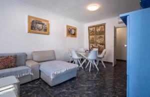 a living room with a couch and a table and chairs at CASA VELA BLANCA in San José