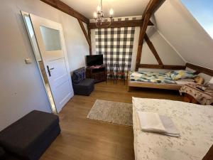 a attic room with a bed and a table at Ośrodek Wypoczynkowy Lido Noclegi in Antonin