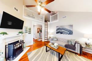ein Wohnzimmer mit einem Sofa und einem TV in der Unterkunft Luxury on Piedmont in Atlanta