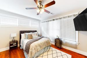 a bedroom with a bed and a ceiling fan at Luxury on Piedmont in Atlanta