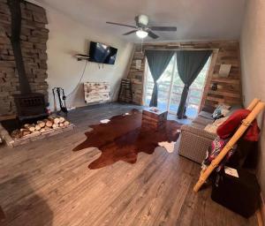 a living room with a couch and a fireplace at Cozy Cabin in Florissant