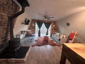 a living room with a cow laying on the floor at Cozy Cabin in Florissant