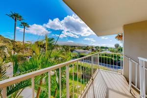 a balcony with a view of the ocean and palm trees at Hale Li'ili'i at Keawakapu #201 in Wailea