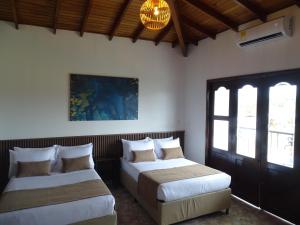 Voodi või voodid majutusasutuse Hotel Palmas De Alcalá toas