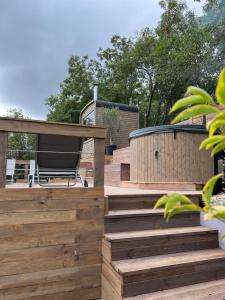 a wooden deck with a hot tub and a spa at Tinutul Luanei Glamping Resort in Bozioru