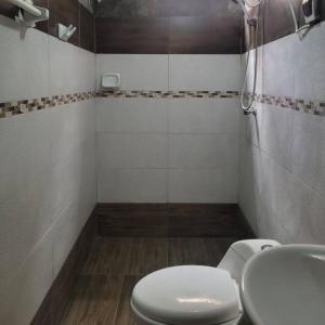 a bathroom with a white toilet and a sink at Apartamento en Huancayo in Huancayo +10 photos