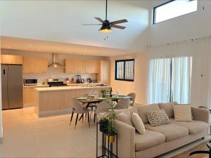 a living room and kitchen with a couch and a table at Penthouse Paradise with Jacuzzi in Cap Cana in Punta Cana