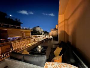 a balcony with couches and a bed on a building at Peaceful 3 Bedroom apartment in Athens center in Athens