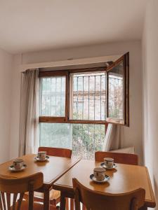 a dining room with two tables and a window at Posada de San Isidro in San Isidro