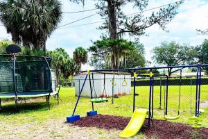 een speeltuin met een schommel in een park bij Gainesville GameDay Getaway 3/2 in Gainesville