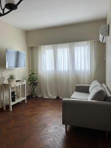 a living room with a couch and a television at Departamento Caseros in Salta