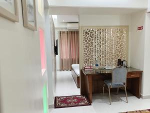 a office with a desk and a chair in a room at Hotel Red Roof Inn in Comilla