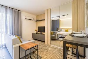 a living room with a couch and a table at Duque by My Way - 100 meters from Santa Casa and UFRGS in Porto Alegre