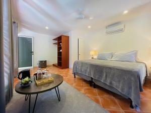a bedroom with a bed and a coffee table at Private Room Playa Negra in Playa Negra
