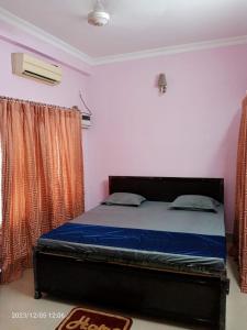 a bedroom with a bed in a room at LOZZY HOMESTAY in Guwahati