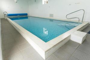 a large swimming pool in a room with at Caravan 521 shuker Barmouth in Talybont
