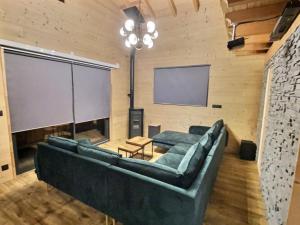 a living room with a couch and a projection screen at Chalet deS'AMY et sa terrasse pour 8/10 personnes in Font-Romeu-Odeillo-Via