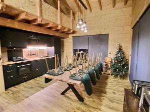 a kitchen with a table with chairs and a christmas tree at Chalet deS'AMY et sa terrasse pour 8/10 personnes in Font-Romeu-Odeillo-Via