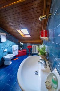 a bathroom with a white tub and a toilet at Il Terrazzino 51 in Bellagio