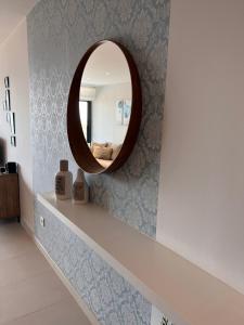 a mirror on a wall with blue wallpaper at Apartment-de-la-luz-calpe in Calpe