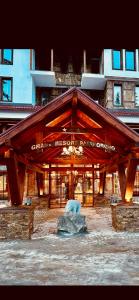 a building with a bear in front of it at Grand resort luxury apartment in Pamporovo