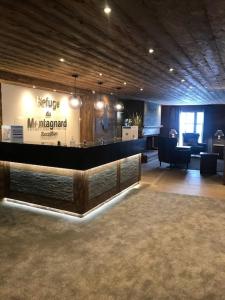 a large room with a lobby with a reception desk at Le Refuge d'Elyze in Arc 1950 +33 photos