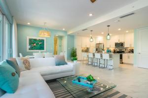 a living room with a white couch and a table at One Particular Harbour 387-101 in Bradenton