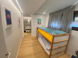 a bunk bed in a room with a hallway at Villa Bella Vista in Castelldefels