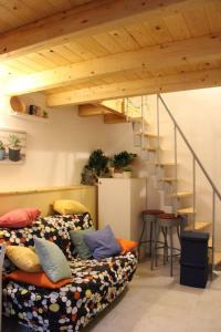 a living room with two couches and a staircase at 4 posti letto vicino pala alpitour! in Turin
