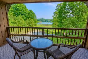un tavolo e due sedie su un balcone con vista di Lakewood Cottage a Logan