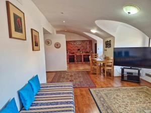 a living room with a couch and a dining room at Studio Karlův Most in Prague
