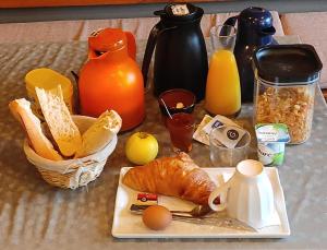 a table topped with a plate of bread and eggs at La vita e bella in Saint-Jean-Pied-de-Port