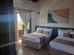 Voodi või voodid majutusasutuse Hotel Palmas De Alcalá toas