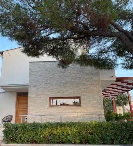 a house with a window on the side of it at Pine Tree Villa in Pakoštane