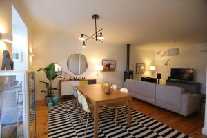 a living room with a table and a couch at Régua Pine House in Peso da Régua