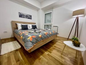 a bedroom with a large bed in a room at Green Apartment in Skopje