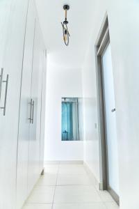 a hallway with glass doors and a mirror at Monarch Villas - Kilifi in Vipingo