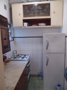 a kitchen with a white refrigerator and a stove at Departamento 2 ambientes Centro de Mar del Plata in Mar del Plata