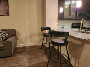 a kitchen with two bar stools and a counter at Home at Energy corridor in Houston