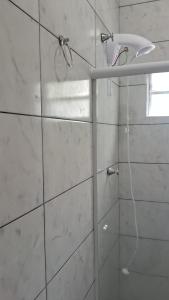 a shower with a shower head in a bathroom at HORTA DO TOMATE in Bombinhas +17 photos