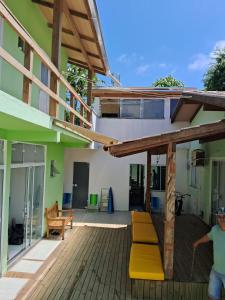 a patio with yellow benches on a building at HORTA DO TOMATE in Bombinhas