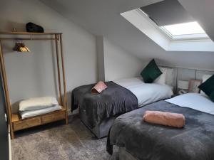 a bedroom with two twin beds and a mirror at 20 mins to central London, Stylish sky views 2 bed in London